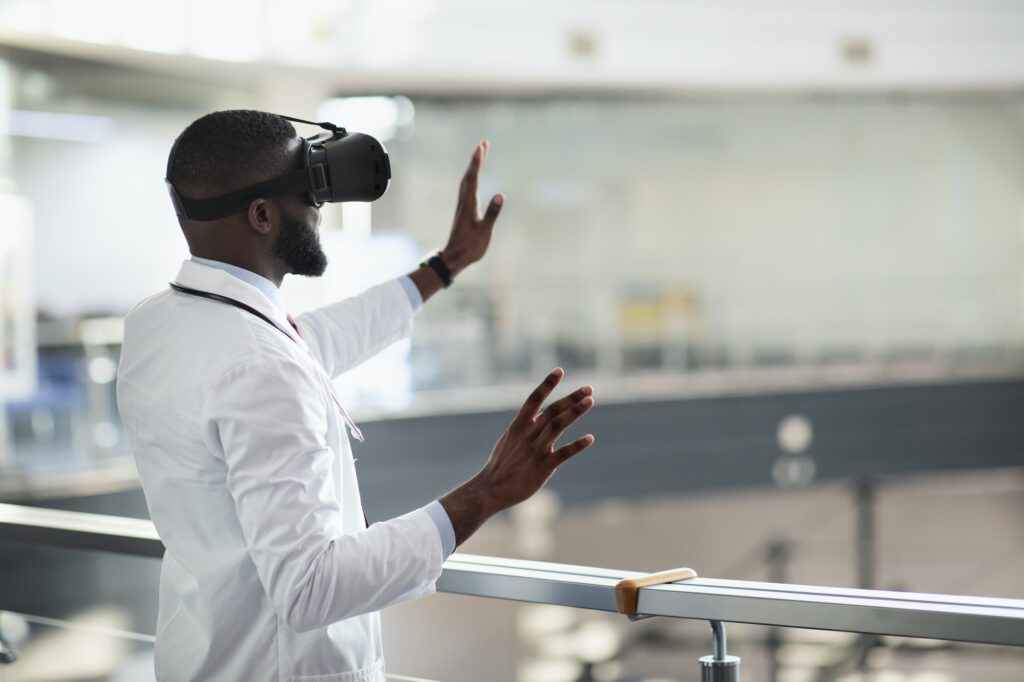 Back view of black doctor in VR glasses, copy space